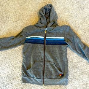 Aviator Nation 5 stripe blue and gray hoodie. Missing hoodie string